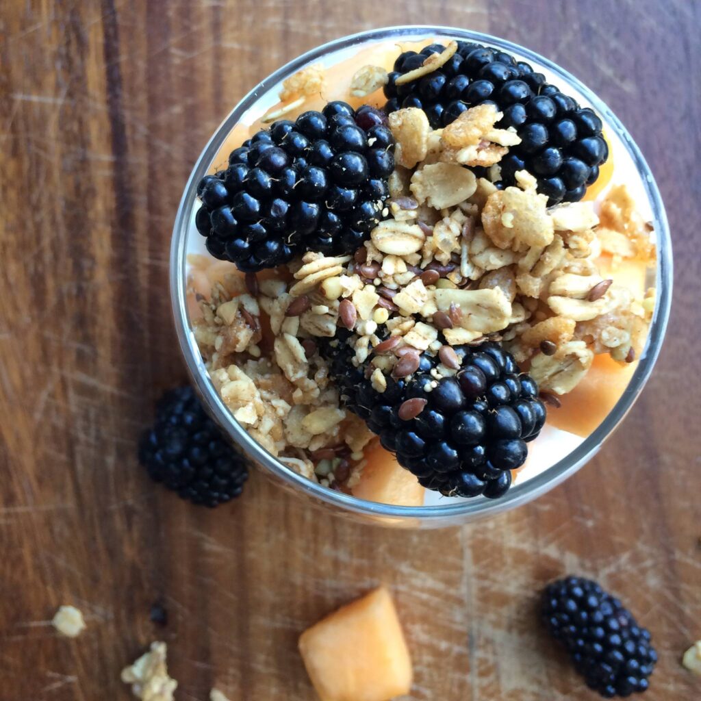 Fruit Parfait featuring blackberries and cantaloupe and granola in image
