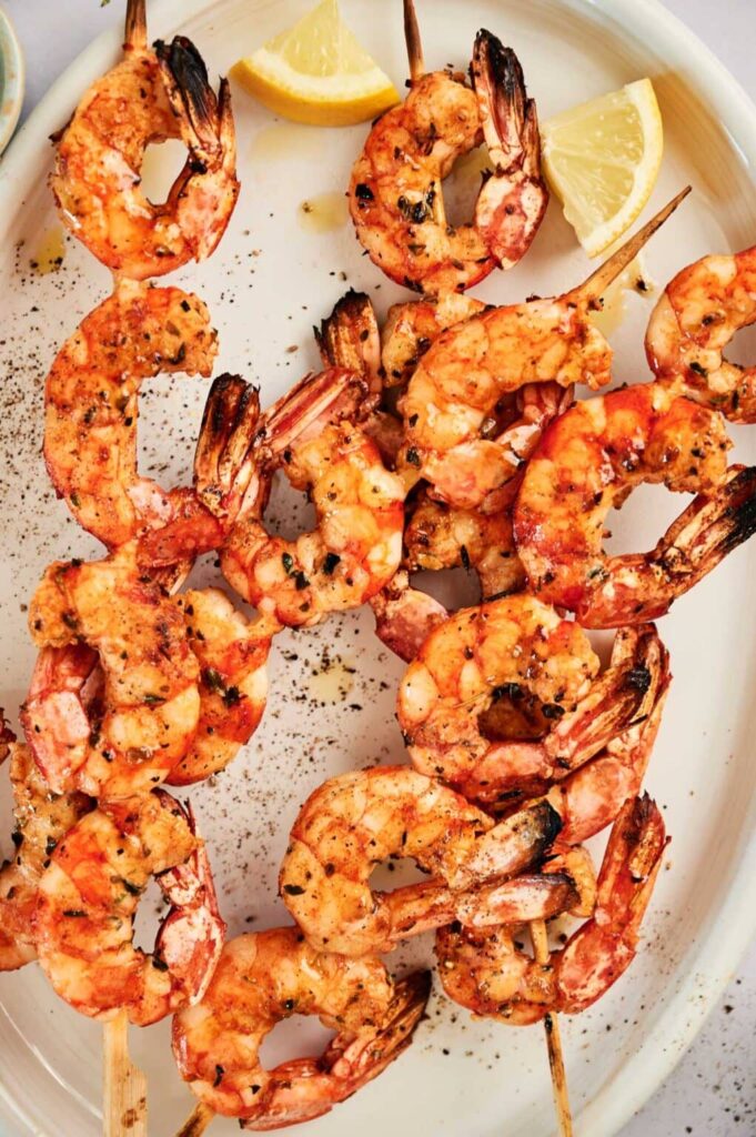 Shrimp Skewers with Lemon Wedges in Background
